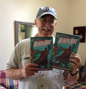 Ron Fortier holds up his latest comic book creation, Guns of the Black Bat. (Story: Ron Fortier, Aaron Shaps Art: Silvestre Szilagyi Cover: Michael Stribling)