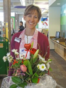 Children's Librarian Amy Holzworth with a bouquet of flowers