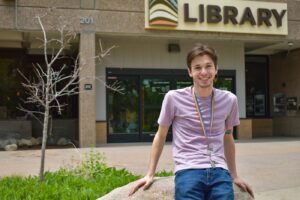 man smiling outside a library