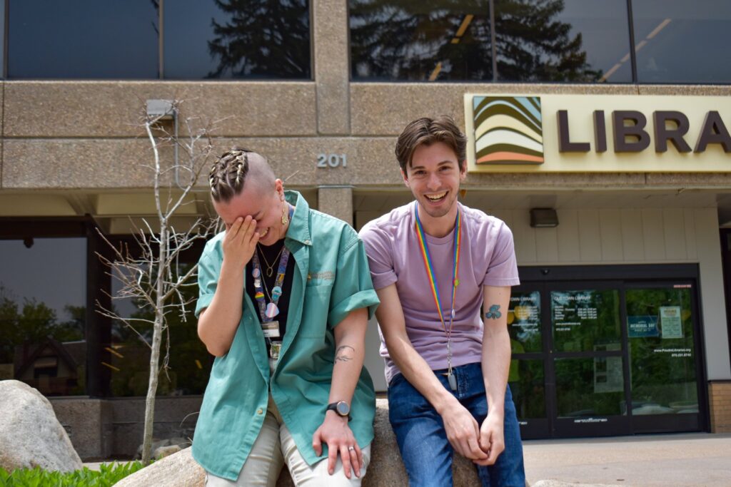two men laughing outside a library