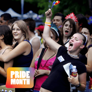 Woman waving rainbow flag at Pride Parade