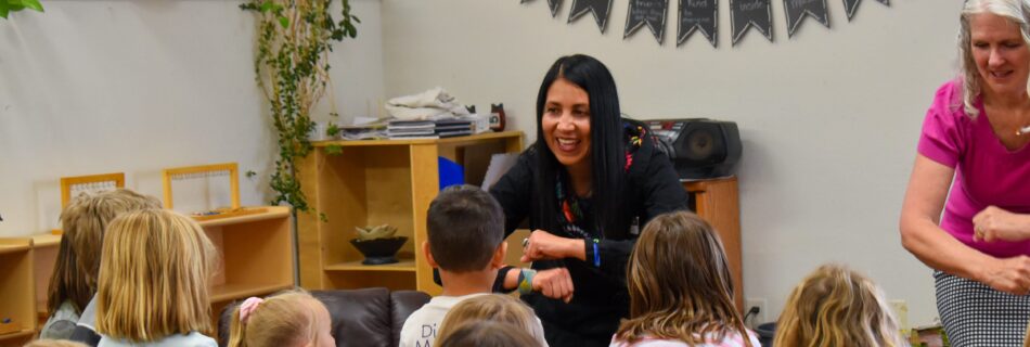 latina woman guiding a children's storytime