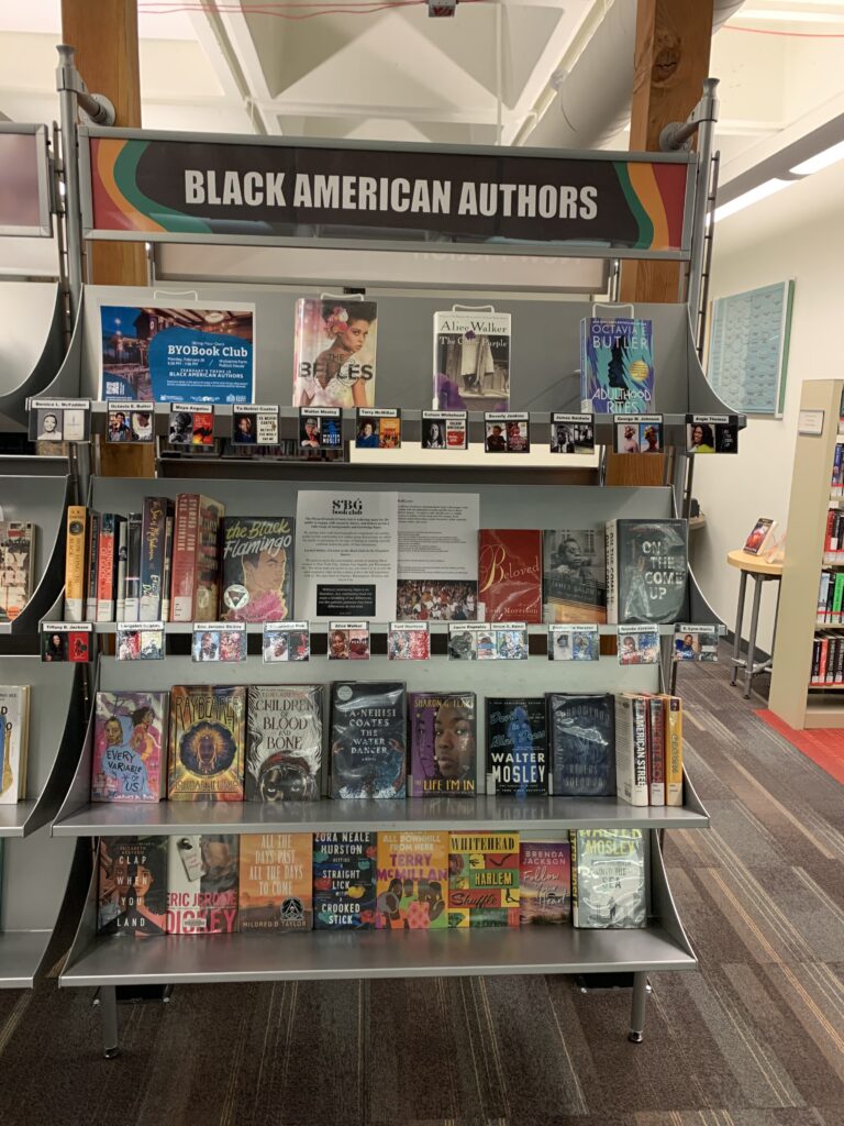 adult black american author's book display in a library